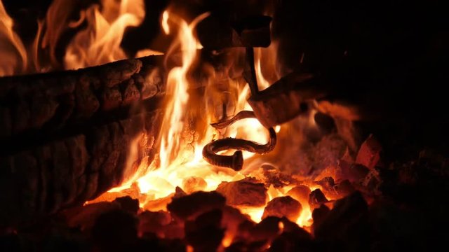 Sparkling furnace flame with high forks in an old Ukrainian smithy workshop