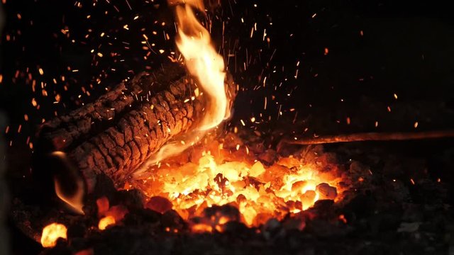 Raging furnace fire with a tongue looking like a spirit with big eyes in a smithy  
