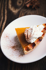 Slices of pumpkin pie with whipped cream, Thanksgiving day dessert