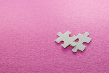 pieces of puzzle on pink felt background