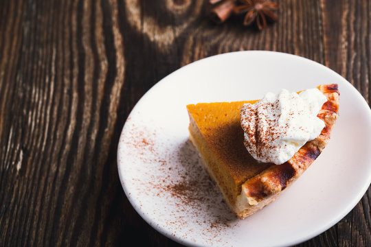 Slices of pumpkin pie with whipped cream, Thanksgiving day dessert