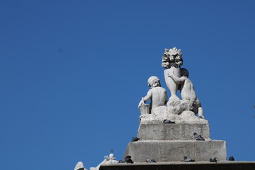 Fototapeta na wymiar Estatua de unos niños en una puerta del Parque del Retiro de Madrid, España