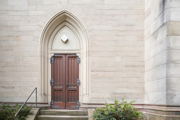 Fototapeta na wymiar Beautiful antique door, entrance to the Evangelical Church. Baden Baden, Germany