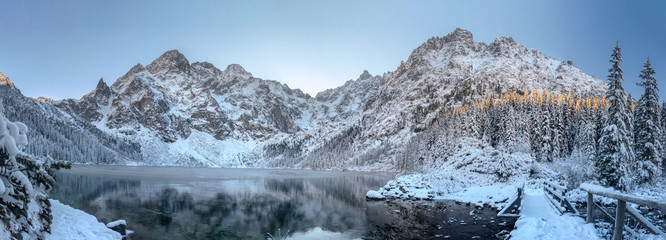 Panorama winter mountains. Scenery winter. Beautiful frosty and snowy nature. Ice mountain lake....