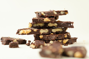 Homemade dark chocolate with walnut. Raw chocolate with nuts, kerob, stevia, acai, guarana. Selective focus, close up
