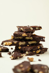Homemade dark chocolate with walnut. Raw chocolate with nuts, kerob, stevia, acai, guarana. Selective focus, close up