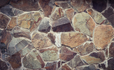 Stone wall of pieces of granite. Horizontal background image.