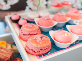 Sweet pastel peach and pink colorful set of afternoon tea in Sakura or Cherry Blossom theme. Tasty and delicious dessert, chocolate, bakery and pastry. Good for high tea party or Birthday celebration.