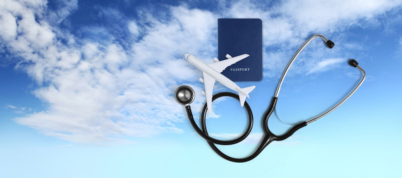 International Medical Travel Insurance Concept, Stethoscope, Passport And Airplane On Blue Sky Background