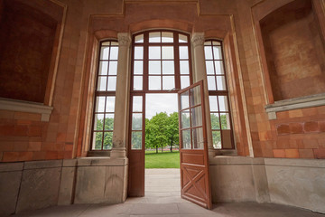 Beautiful and old large full-wall glass window with a door and access to the garden. European architecture