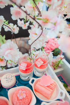 Sweet Pastel Peach And Pink Colorful Set Of Afternoon Tea Or High Tea Party In Sakura Or Cherry Blossom Theme. Tasty And Delicious Dessert, Chocolate, Bakery And Pastry. Non-English Translation-Sakura