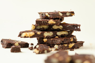 Homemade dark chocolate with walnut. Raw chocolate with nuts, kerob, stevia, acai, guarana. Selective focus, close up