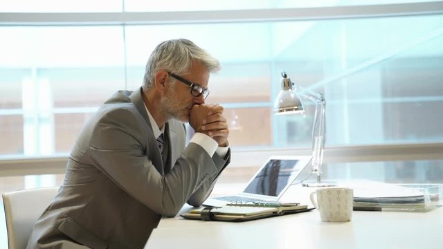 Stressed businessman sitting at desk
