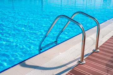 Swimming pool in curved shape with stairs