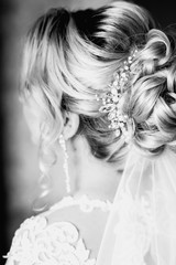 Fototapeta na wymiar Bride hairstyle, bride dress up at home in a pink robe