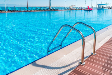 Swimming pool in curved shape with stairs