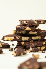 Homemade dark chocolate with walnut. Raw chocolate with nuts, kerob, stevia, acai, guarana. Selective focus, close up
