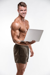 Muscular bodybuilder with laptop
