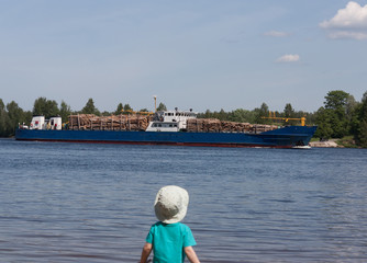Fototapeta na wymiar cargo ship transporting timber along the river