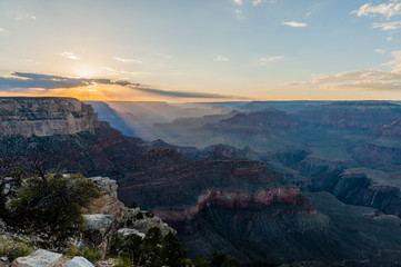 The setting sun sinking below the horizon of the Grand Canyon, near Yavapai point on the southern canyon rim.