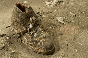 Grungy old boot on dirty floo