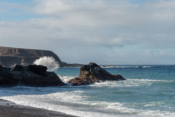 Fototapeta premium Waves splashing on rocks, Ajuy beach, Fuerteventura, Canary Islands. 