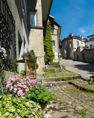 histoirc cobblestone streets and buildings in the old town of the Swiss city of Fribourg with tourist walking around