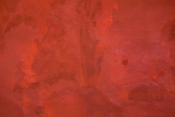 Red painted wall background. Grunge retro aged outside surface from cement or concrete painted in red color