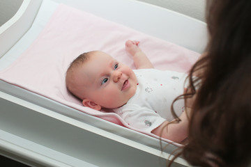 3 Month Old Cute Baby Girl, Infant ,lying on the white chanting table, laughs, looking on her Mother, New family concept, The most Beautiful Baby Princesse, Happy Baby Girl