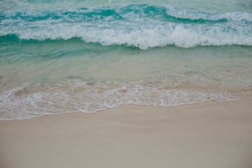 Tropical beach on high season The waves on sand beach and beautiful sky.