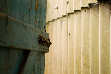 An old wooden blue door to the outside