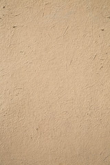 Textural background, plaster with a pile effect painted in beige color.