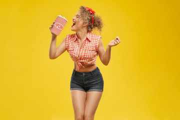 Sexy pin up girl holding bucket with popcorn.