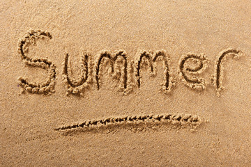 Summer word written in sand on a sunny beach holiday vacation travel destination sign writing message photo