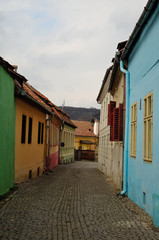 Fototapeta na wymiar Colorful Houses on a Street in the Sighisoara Fortress
