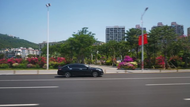 sunny day sanya city road trip traffic street side view pov panorama 4k hainan china