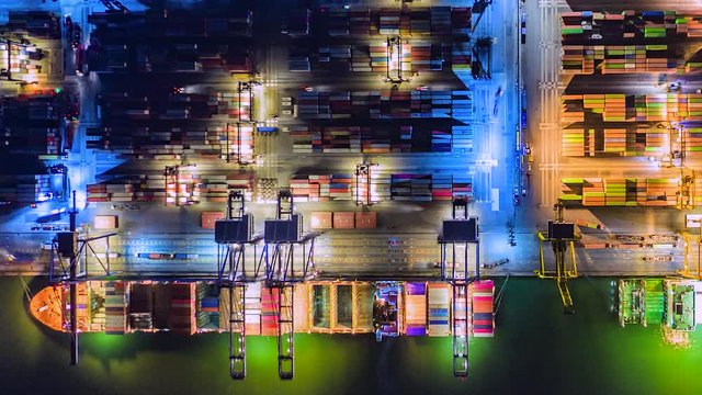 4K Time lapse industrial port with containers from top view or aerial view. It is an import and export cargo port where is a part of shipping dock