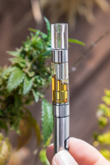 E-Weed Vape Pen Marijuana Extract Oil In Cartridge Close Up