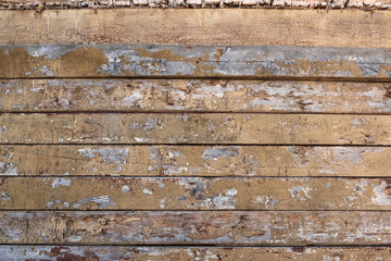 Old cracked boards with traces of colored paint.