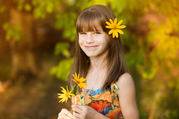 Portrait of adorable girl with flower in hairs