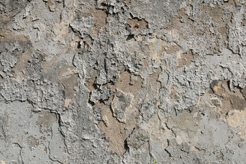 Old textured concrete wall with traces of putty and peeling paint