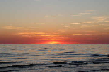 Naklejka na ściany i meble Beautiful sunset at the sea