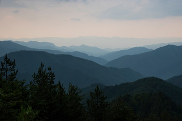 Panoramic landscape silhouettes of blue mountains with mist after rain in Rhodopi range