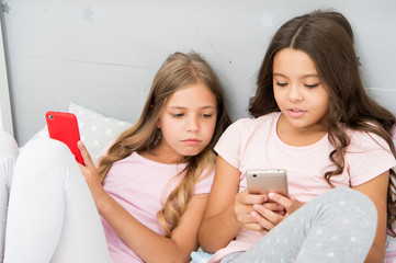 Mobile addicted. Girl play games smartphone online. Pajamas party concept. Happy childhood. Kids...