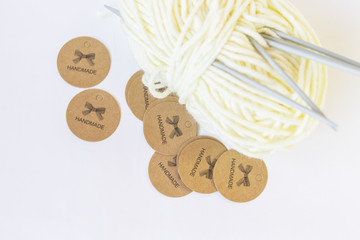 Milk color yarn ball with needles on the white background. Craft Cards with  word 