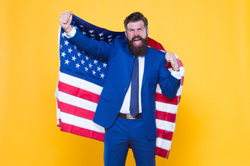 Honour and glory to my country. Happy businessman holding old glory american flag on yellow background. Bearded man in formalwear enjoying glory and success. Hard work brought glory to him
