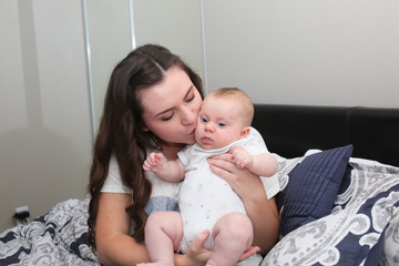 Two Beautiful sisters, Teenage Mother, kissing 3 month old Baby Girl