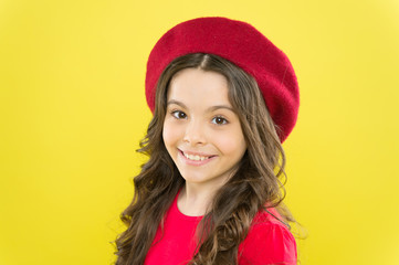 Hairdresser service. Kid girl long healthy shiny hair. Perfect curls. Kid cute face with adorable curly hairstyle wear beret hat. Little fashionista. Little girl grow long hair. Styling of curly hair