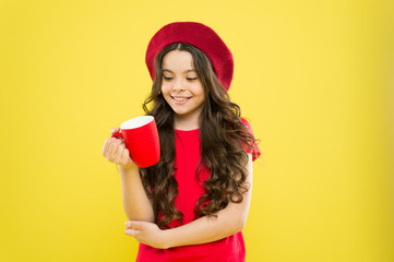 Child hold mug. Drinking tea juice cocoa. Relaxing with drink. Child smiling drink beverage. Homebrewed drink. What is your favorite juice. Drink enough water. Girl kid hold mug yellow background