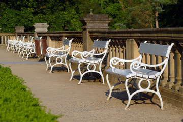 white benchs in the castle garden